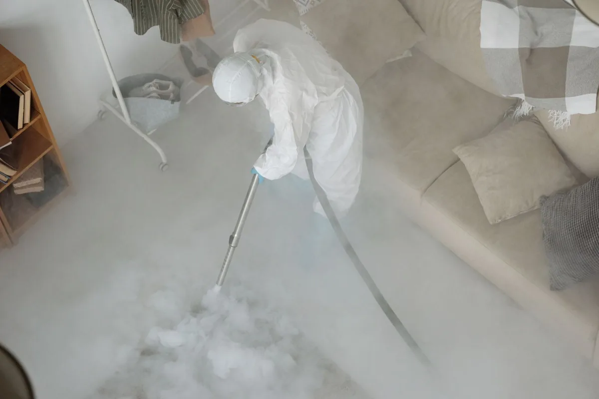 Biohazard cleanup technician in protective equipment, Adelanto, CA